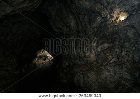 Beautiful Cave. View From Inside Dark Dungeon. Textured Walls Of Cave. Background Image Of Undergrou
