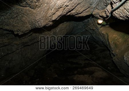 Beautiful Cave. View From Inside Dark Dungeon. Textured Walls Of Cave. Background Image Of Undergrou