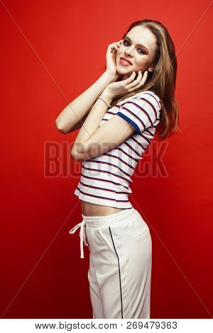 Young Pretty Teenage Girl On Bright Red Background, Happy Smilin