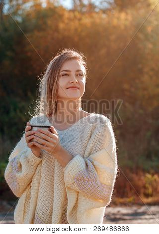 Beautiful Admiring Woman Drinking Hot Tea From Thermos Cup With Backligth Sun.