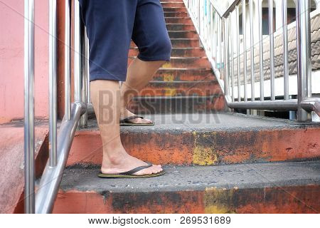 A Male Legs Standing On Old Step Of City Overpass With Strong Steel Handrails