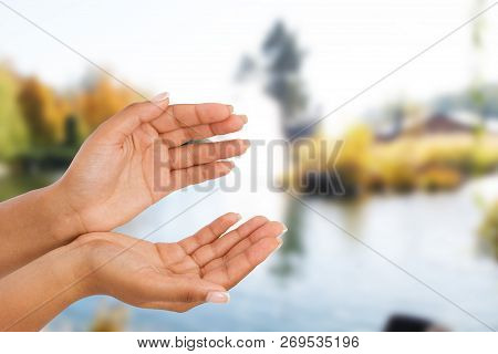 Black Female Hand Two Palm Up, Handbreadth Isolated On Blurred River Background. Front View. Mock Up
