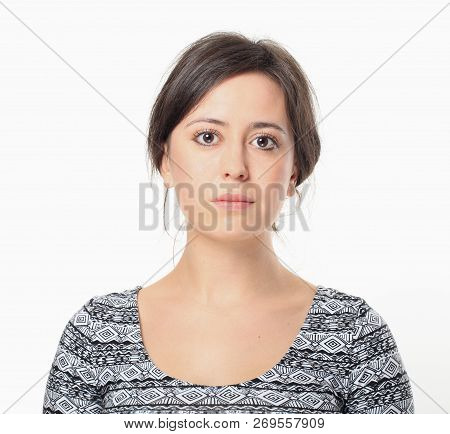 Serious Pretty Woman Portrait Isolated On White Wall