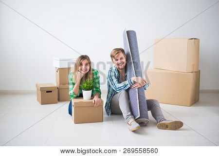Relocation, Real Estate And Moving Concept - Young Cheerful Couple Moving Into Their New Home
