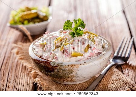 Swabian Sausage Salad - Elsasser Wurstsalat On Wooden Background.