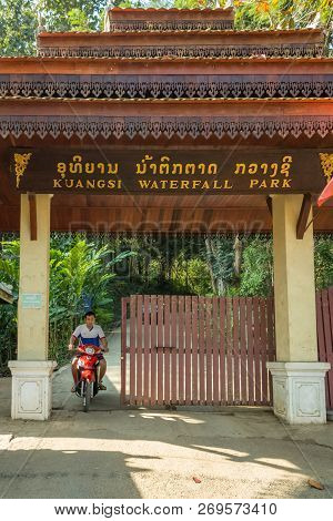 Luang Prabang, Laos - January 29, 2018: Laotian Man With Motorbike At The Entrance Of Kuangsi Waterf