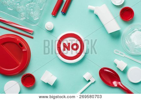 Top View Of No Sign And Disposable Plactic Wares On Blue Background