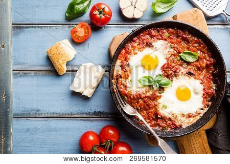 Shakshuka, Fried Eggs In Tomato Sauce In Iron Frying Pan. Typical Israel Food. Top View.