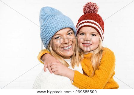 Family Portrait Of Looking At Camera In Winter Clothes Isolated On White