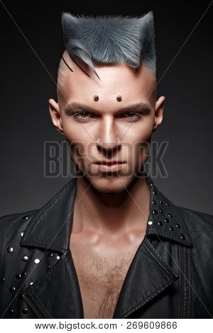 Young Man With Blue Hair And Creative Makeup And Hair.