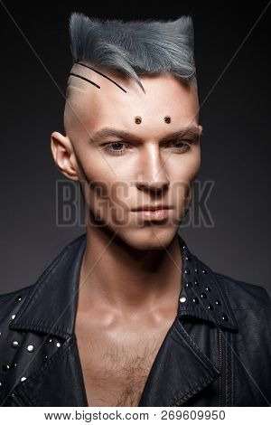 Young Man With Blue Hair And Creative Makeup And Hair.