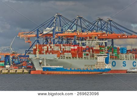 PORT OF ROTTERDAM, THE NETHERLANDS - SEPTEMBER 17, 2015: Huge container ship in port being loaded at the Euromax terminal, Rotterdam. Rotterdam is the busiest cargo port of Europe