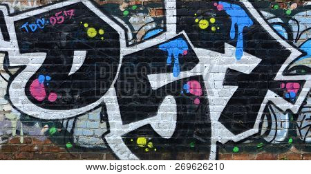 Full And Acomplished Graffiti Artwork. The Old Wall Decorated With Paint Stains In The Style Of Stre