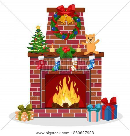 Fireplace Of Brick Decorated With Socks, Christmas Tree, Candles, Bells, Toy, Gifts Around.