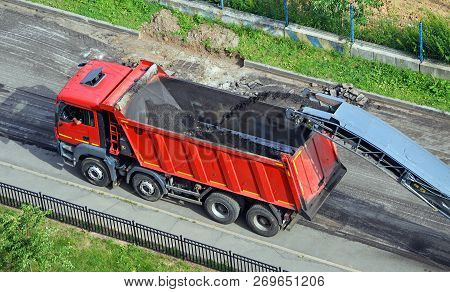 Moscow, Russia - July, 2015: Road Construction Work. Shredded Removed The Old Asphalt Pours From The