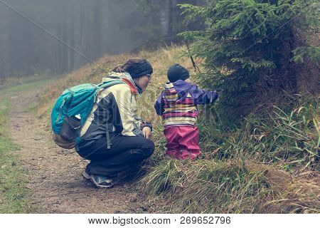 Active Mother Exploring Nature With Her Daughter.