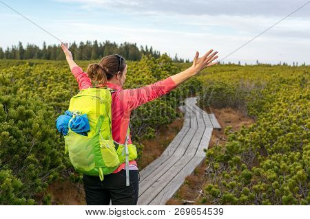 Attractive Brunette Raising Hands While Enjoying The View.