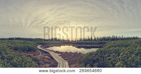 Spectacular Sunset View Of A Lake Surrounded By Wetlands.
