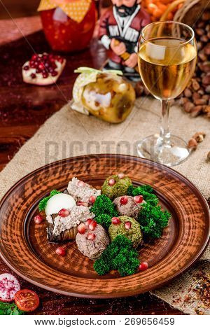 Georgian Dish - Phali Of Spinach And Meat On A Brown Plate On A Wooden Background. Close-up