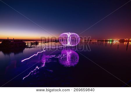 Amazing Laser Fireshow Performance In The Night Blue Sky With Reflections In The Sea Water