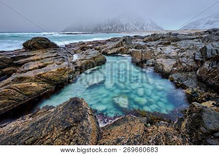 Rocky coast of fjord of Norwegian sea in winter. Lofoten islands, Norway