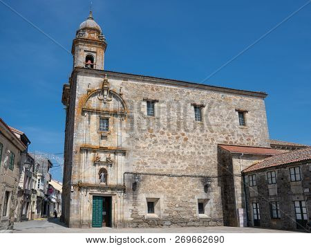 Melide, Spain - August 30, 2018: Main Church In The City Center Of Melide With Blue Sky On August 30