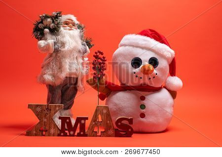 Santa Claus, Snoman Toy And Wooden Xmas Text Sign. Seasonal Presents For December Holiday