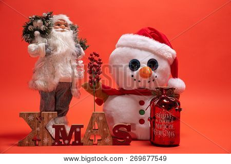 Santa Claus, Snoman Toy And Wooden Xmas Text Sign. Seasonal Presents For December Holiday