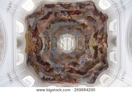 WURZBURG, GERMANY - JULY O4, 2018: Adoration of the Holy Trinity by saints and angels ceiling fresco in Neumunster Collegiate Church in Wurzburg, Germany
