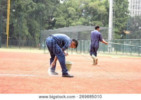 Jakarta, Indonesia-november 2, 2018: Worker Drawing A Line For A Softball Field Located At Gelora Bu