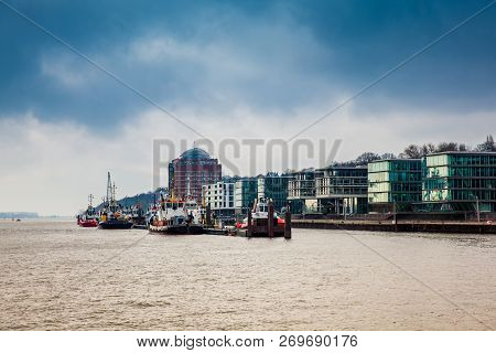 Tugboats Docked At The Hamburg Port On The Banks Of The Elbe River
