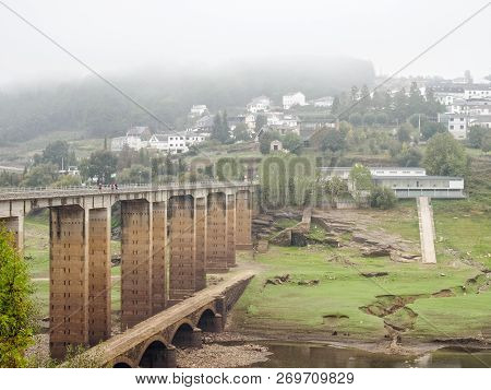 Camino Pilgrims Walk Across The New Bridge Over The Minho River In A Foggy Autumn Morning - Portomar