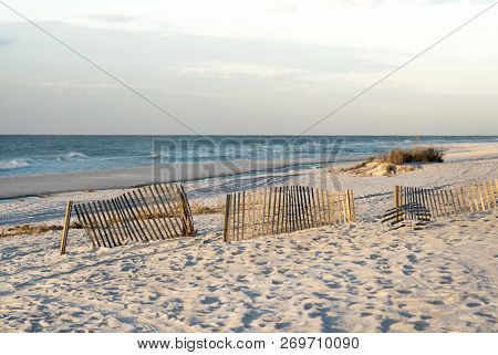 Sand Fences And Tide Pools On Florida Beach At Low Tide, Early Morning, Warm Light.