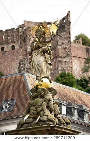 German And Foreigner Travelers People Walking And Visit Madonna Statue At The Corn Market Square In