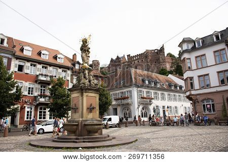 German And Foreigner Travelers People Walking And Visit Madonna Statue At The Corn Market Square In
