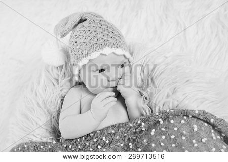 A Naked Newborn Baby Sleeps In A Christmas Hat.
