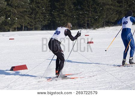 A Woman Cross-country Skiing In The Alps