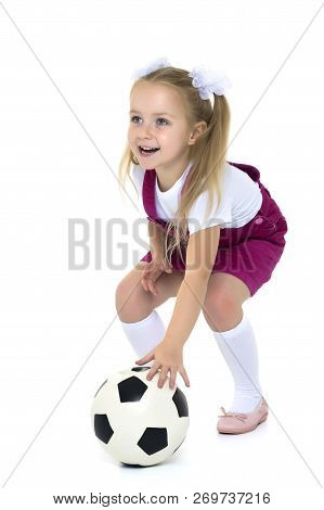 Adorable Little Girl With A Soccer Ball. The Concept Of Childrens Sports, Summer Outdoor Recreation.