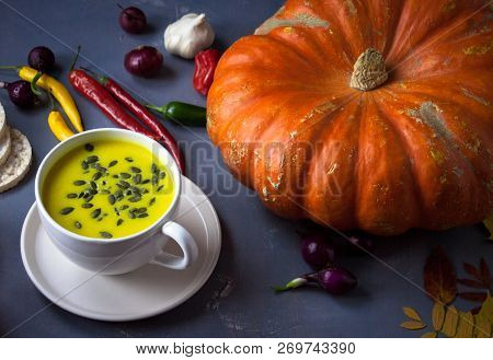 Pumpkin Asian Coconat Cream Soup. Autumn Hot Food. Chili Pepper, Garlic, Red Onion, Big Pumpkin. Dar
