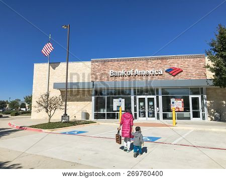 Bank Of American Branch Office With Flying American Flags And Customers Visiting