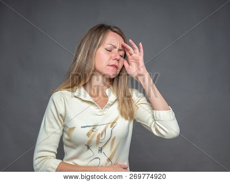 Emotional Woman Holding Hand On Forehead, Suffering From Pain Feeling Bad And Sick. She Having Heada