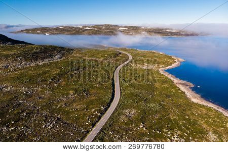 Aerial View. Road Crossing Hardangervidda Mountain Plateau, Clouds Over Lakes, Morning Time. Norway 