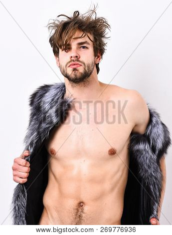 Guy Attractive Fashion Model Posing Fur Coat On Naked Body. Fashion Concept. Richness And Luxury Lif