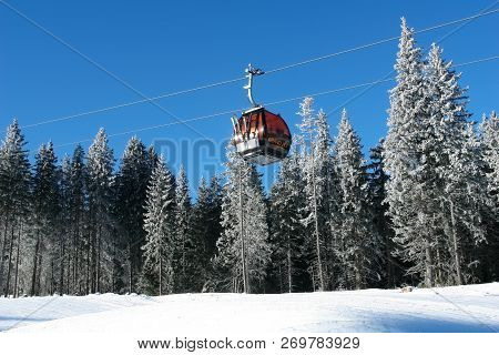 Jasna, Slovakia - January 25, 2017: Cabin Of Cableway On A Background Of Snow-covered Fir Trees On A