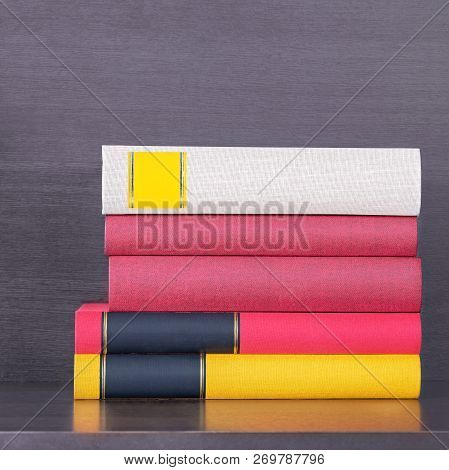Stack Of New Colorful Books In The Wooden Bookself