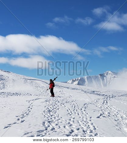 Skier With Skis On His Shoulder And Snowy Mountains At Cold Sun Day. Winter Caucasus Mountains, Geor