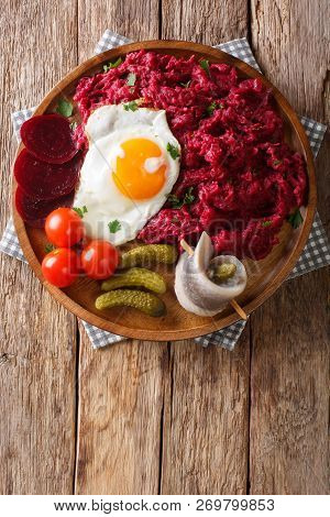 German Cuisine Labskaus Is A Mashed Potato, Corned Beef And Beetroot With Fried Egg, Pickled Cucumbe