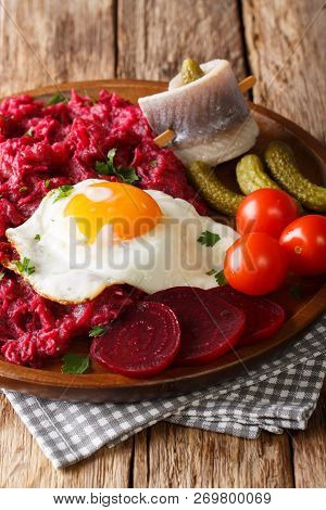 German Cuisine Labskaus Is A Mashed Potato, Corned Beef And Beetroot With Fried Egg, Pickled Cucumbe