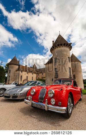 Beaune, France - June 12, 2010: Red Classic Jaguar Xk 140 Sportscar In Front Of The Savigny Castle.