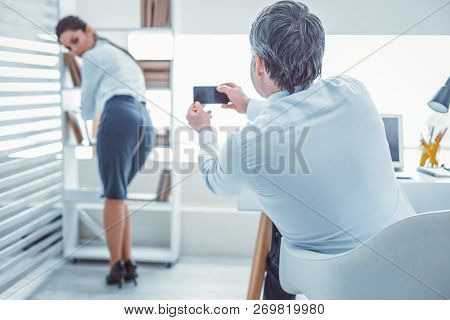 Nasty Boss Making Photos Of His Coworker Back